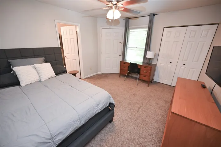 A well-lit bedroom offering a cozy retreat with ample space for relaxation.