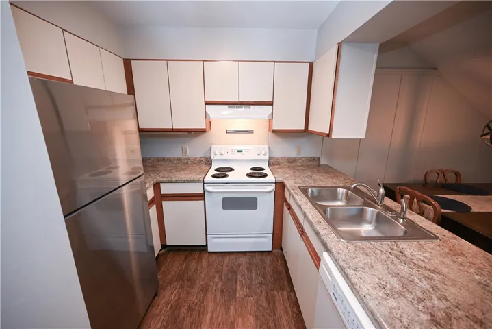 Functional kitchen with ample counter space and classic cabinetry, ready for your culinary adventures.