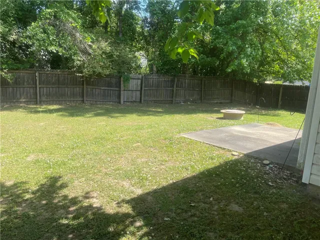 A fenced backyard offers a private outdoor sanctuary, perfect for relaxation or recreation.