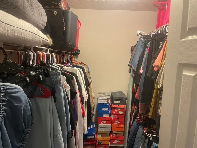 Ample hanging space and shelving create a well-organized closet system.