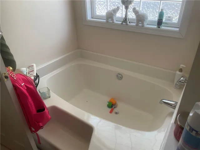 Relax and unwind in this deep soaking tub, complete with an adjacent window for natural light.