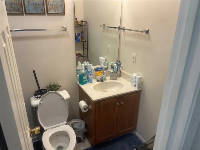 Functional full bathroom with a compact vanity and a commode.