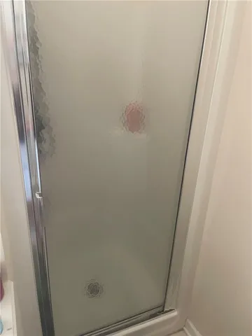 A private, textured glass shower enclosure offers a refreshing daily retreat.
