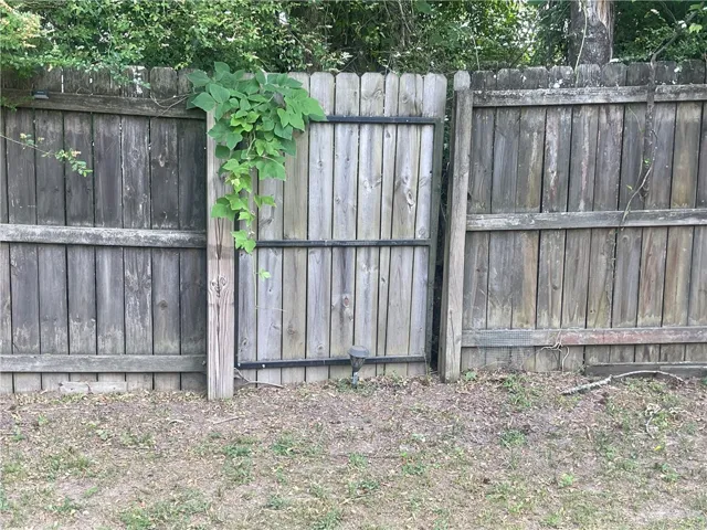 Secure backyard access with a sturdy wood privacy fence.