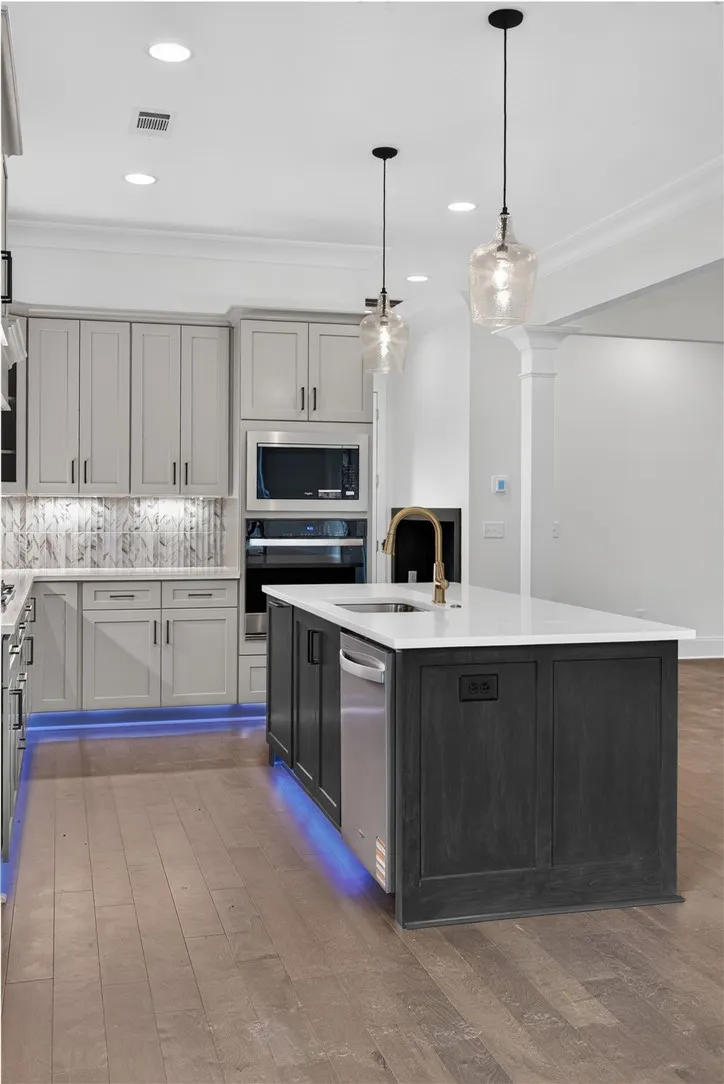 Culinary excellence awaits in this modern kitchen, highlighted by stylish pendant lighting and a spacious island.