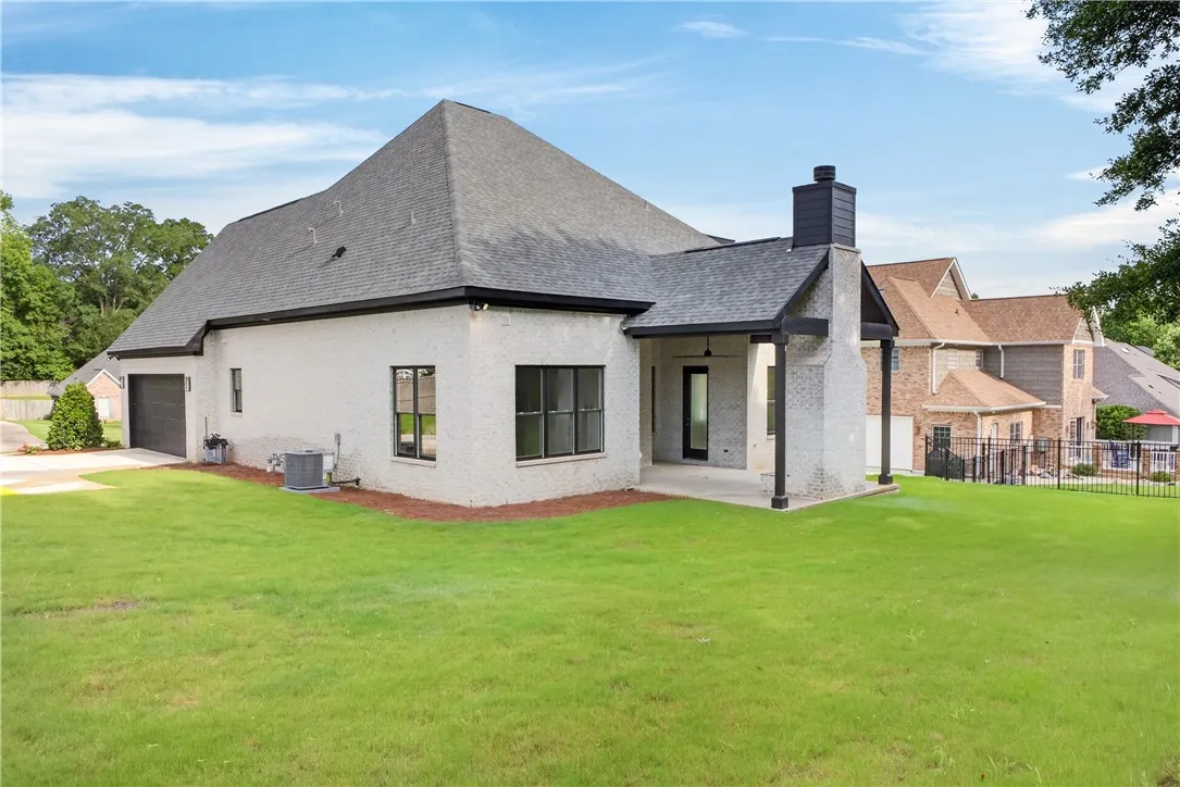 A spacious backyard with covered patio invites relaxation and outdoor enjoyment.