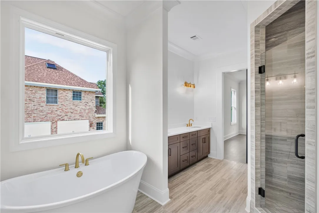 Indulge in relaxation with this bath's deep soaking tub and sleek walk-in shower.