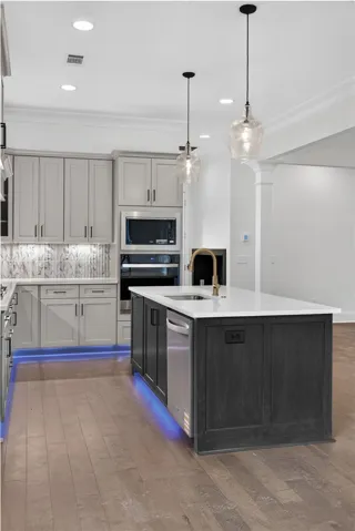 Culinary excellence awaits in this modern kitchen, highlighted by stylish pendant lighting and a spacious island.
