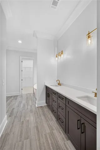 Clean lines define this bathroom with a spacious dual vanity and contemporary lighting.