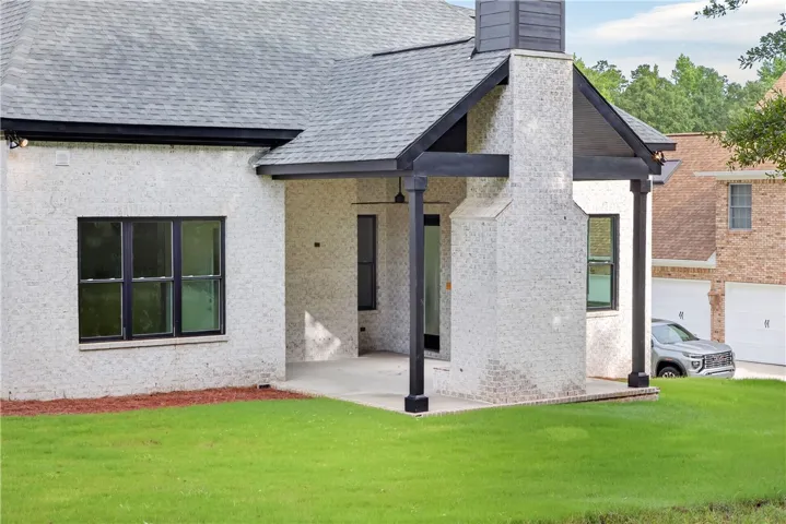 A pristine white brick exterior, complemented by dark trim, presents a charming and modern aesthetic.