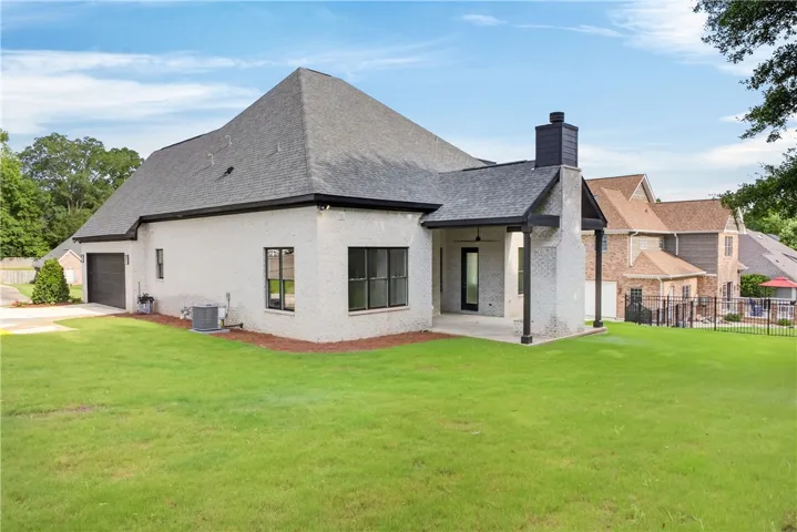 A spacious backyard with covered patio invites relaxation and outdoor enjoyment.
