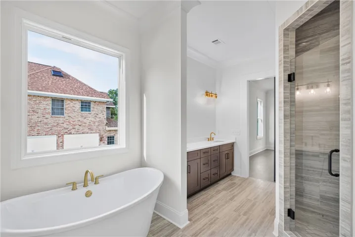 Indulge in relaxation with this bath's deep soaking tub and sleek walk-in shower.