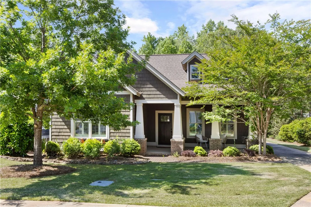 A welcoming front facade with a covered porch and neatly maintained landscaping beckons.