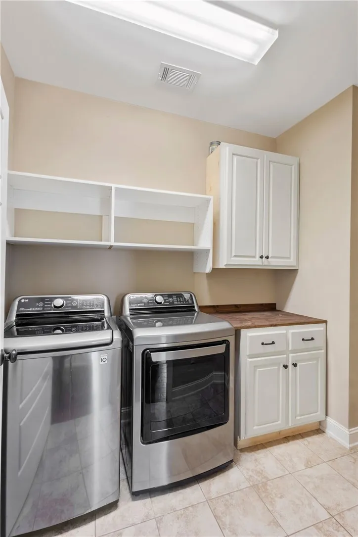 Functional laundry space featuring modern appliances and practical storage solutions.
