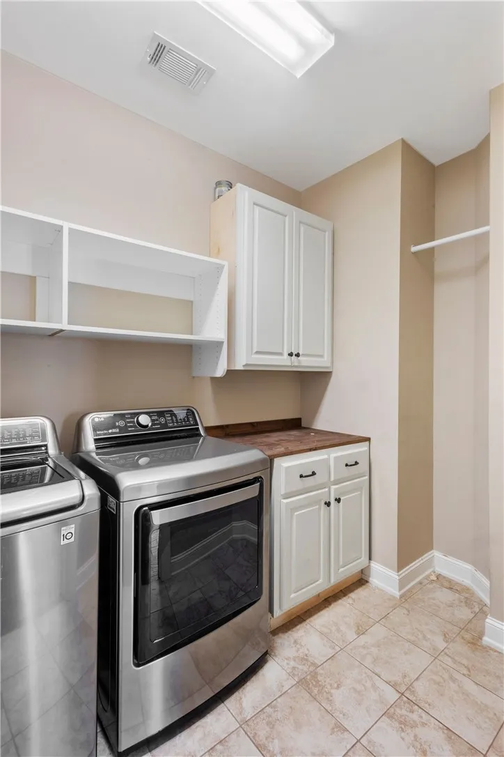 Functional laundry space featuring modern appliances and practical storage solutions.