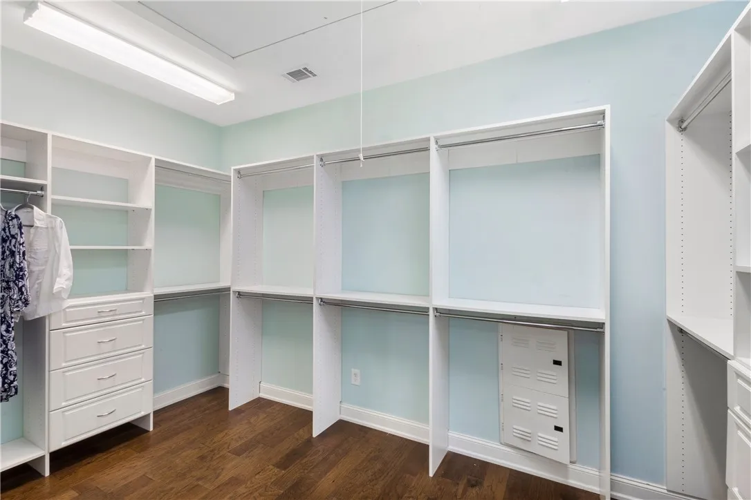 Ample built-in shelving and drawers provide organized storage solutions within this well-appointed closet.