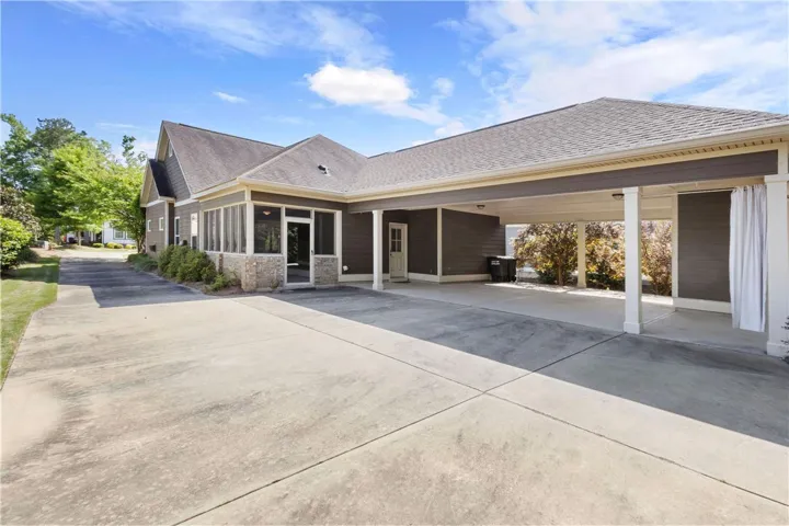 A spacious driveway and covered parking area offer convenient access to this home with a screened porch.