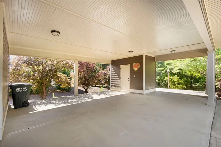 A spacious, sheltered carport offers ample parking and direct access to the home.