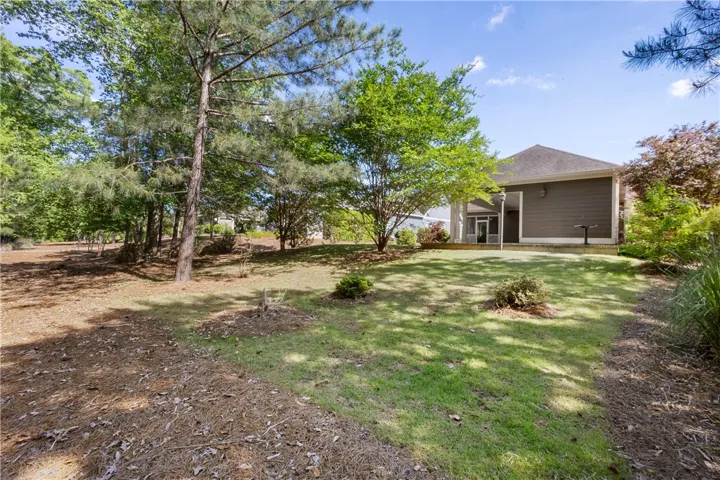 Green landscaping and mature trees complement the exterior of this inviting residence.