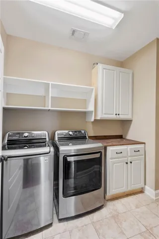 Functional laundry space featuring modern appliances and practical storage solutions.