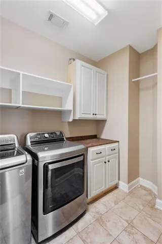 Functional laundry space featuring modern appliances and practical storage solutions.