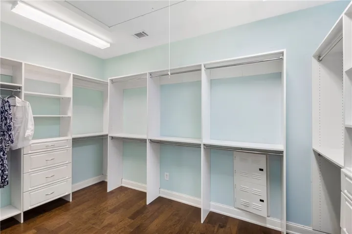 Ample built-in shelving and drawers provide organized storage solutions within this well-appointed closet.