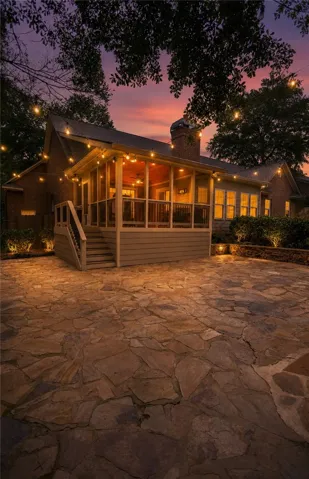Entertain guests on the spacious flagstone patio and screened porch, perfect for evening gatherings.