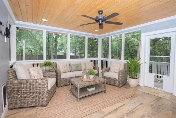 Relax and unwind in this serene screened porch, perfect for enjoying nature's tranquility.