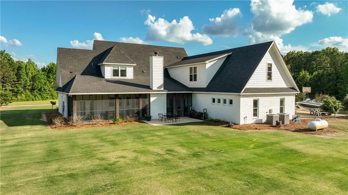 A spacious backyard with verdant grass offers ample outdoor living space.