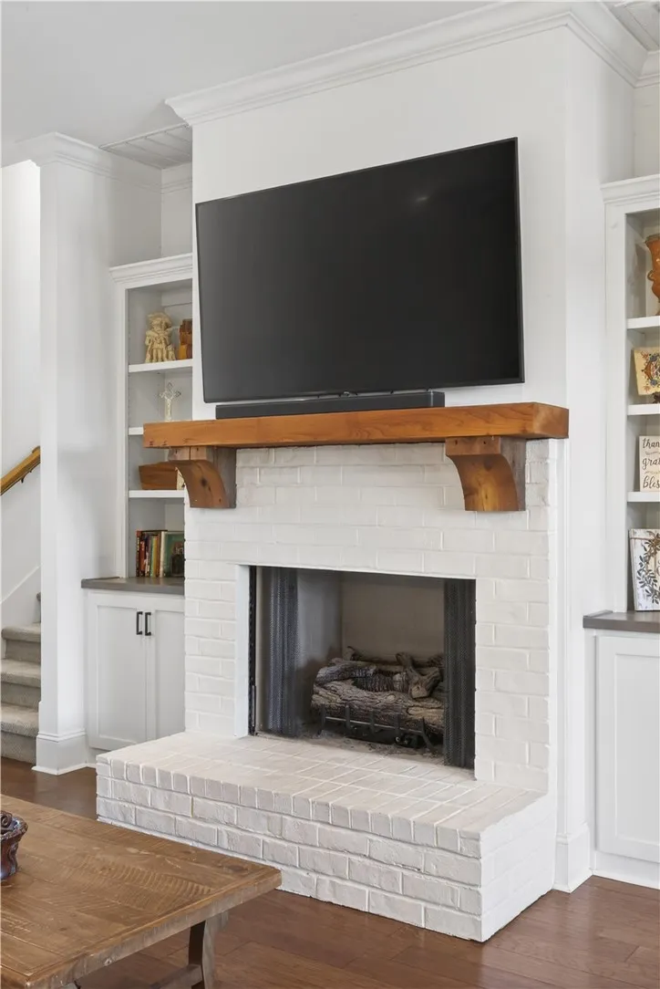 A whitewashed brick hearth provides a cozy focal point in this inviting living area.