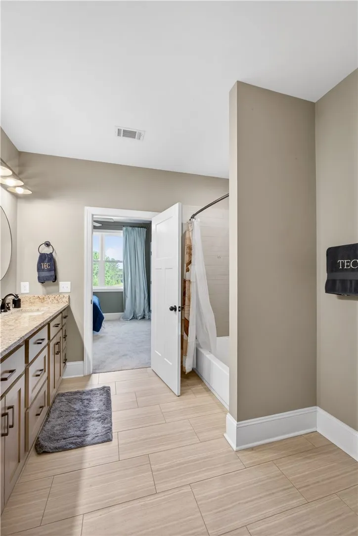 A well-appointed bath offers elegant fixtures and a bright, functional space.