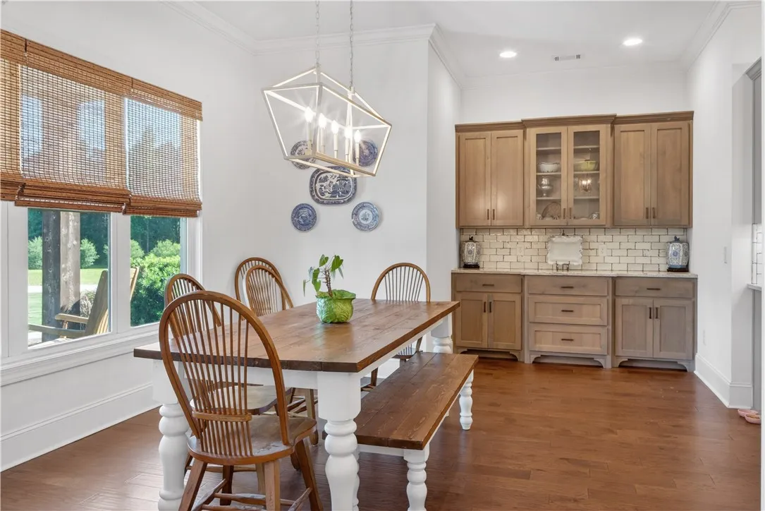 Dine with plenty of natural light, featuring warm wood floors and custom built-in cabinetry.