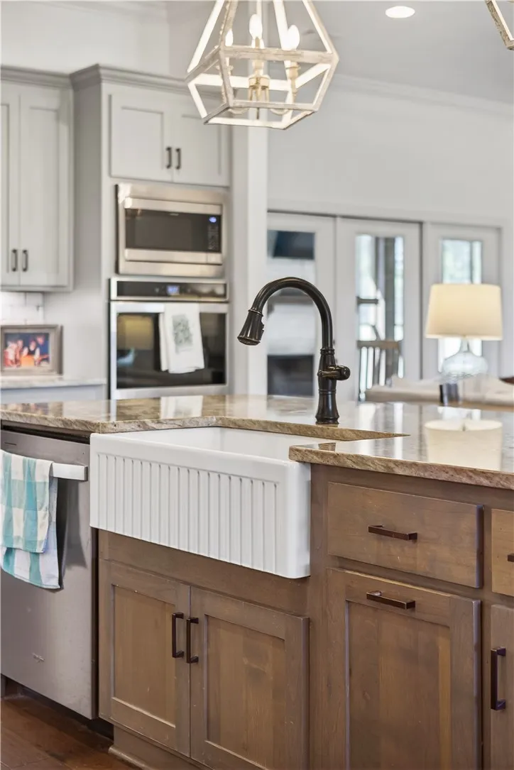 Granite counters and stainless steel appliances outfit this appealing, well-appointed kitchen.