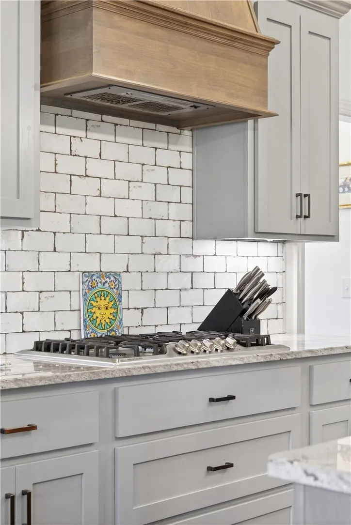 Gleaming counters and subway tile backsplash elevate this kitchen's culinary workspace.