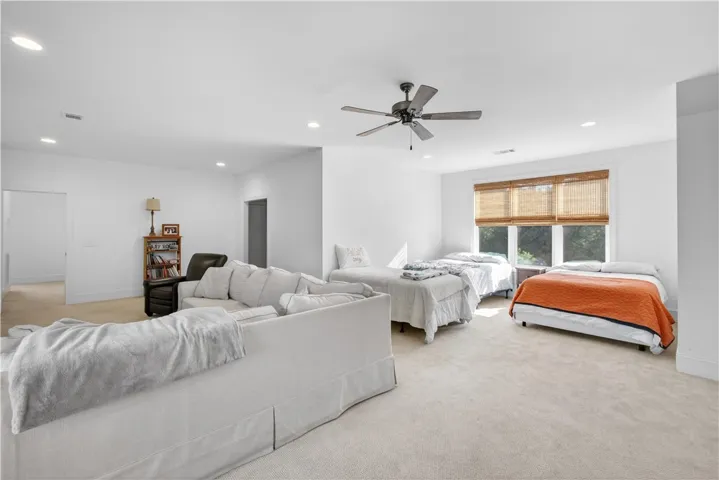 A spacious and inviting room offers comfort and versatility, perfect for entertainment or a guest suite.