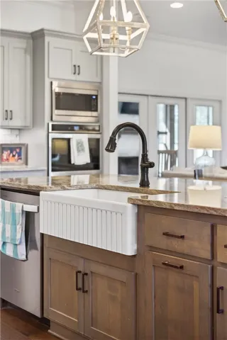 Granite counters and stainless steel appliances outfit this appealing, well-appointed kitchen.