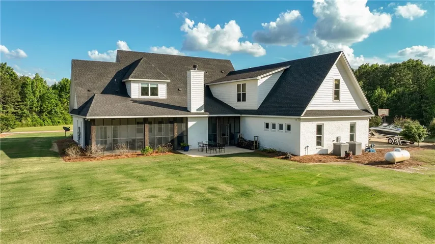 A spacious backyard with verdant grass offers ample outdoor living space.