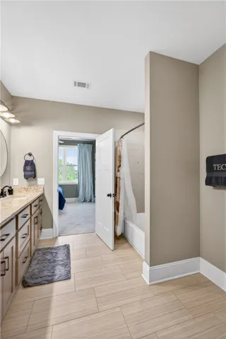 A well-appointed bath offers elegant fixtures and a bright, functional space.