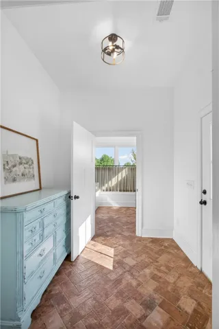 Herringbone brick floors in this spacious Owner's Entry/Mudroom