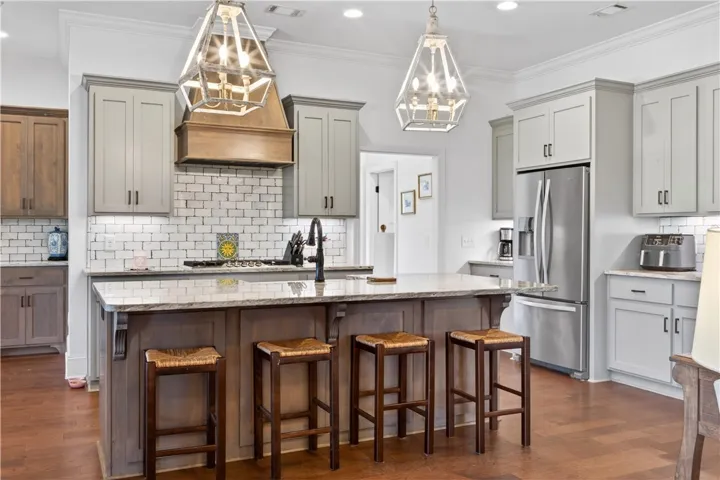 Entertaining adventures await in this naturally illuminated kitchen, boasting a spacious island and gleaming stainless steel appliances.