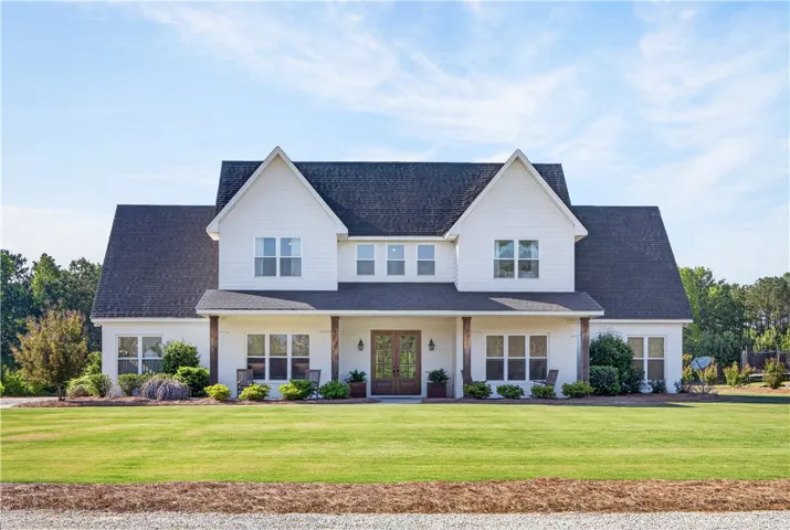 A spacious facade with a welcoming porch and crisp white brick and Hardie offers exceptional curb appeal.