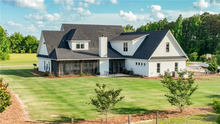 A spacious backyard with mature trees and a screened porch provides ample outdoor living space.