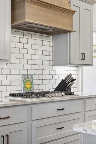 Gleaming counters and subway tile backsplash elevate this kitchen's culinary workspace.