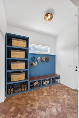 A practical mudroom entry provides organized storage and a convenient seating area.