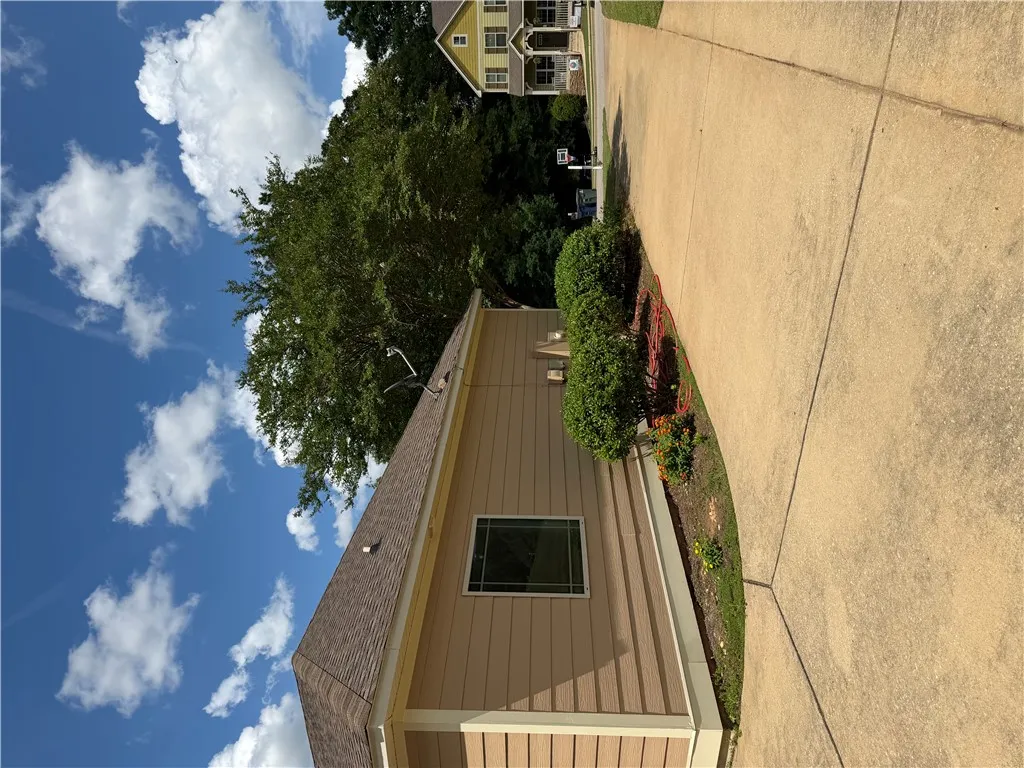 A well-maintained side profile of a home with tidy landscaping and a clear, inviting pathway.