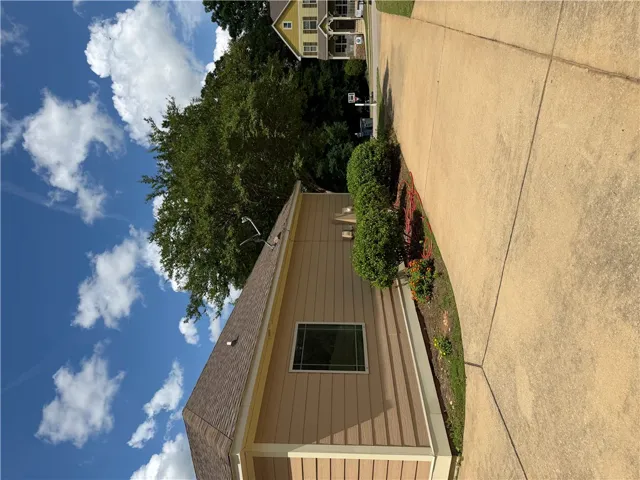 A well-maintained side profile of a home with tidy landscaping and a clear, inviting pathway.