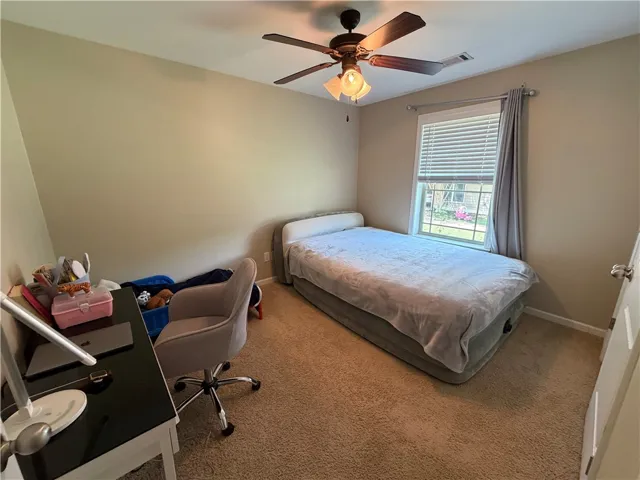 A well-lit bedroom offering a cozy retreat with ample natural light.