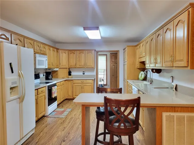 Well-appointed kitchen featuring light-toned cabinetry and practical countertop space.
