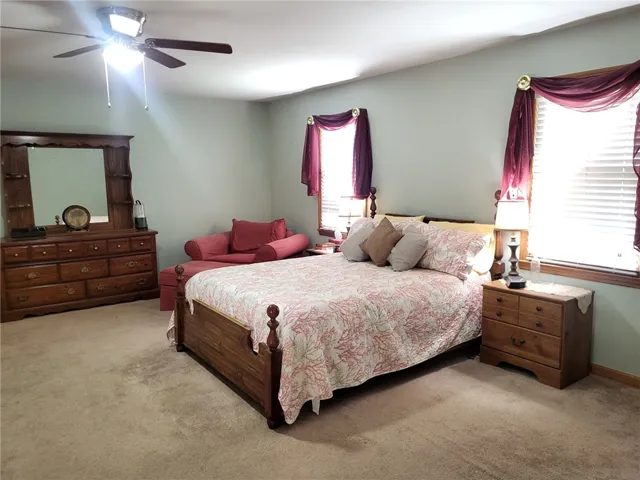 A comforting bedroom space, complete with a ceiling fan for optimal airflow.