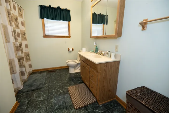 Functional full bathroom featuring a vanity with storage and a combination shower/tub.